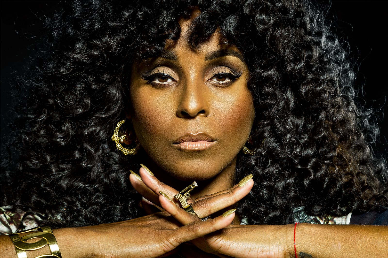 Close portrait of Angela Hunte with curly hair