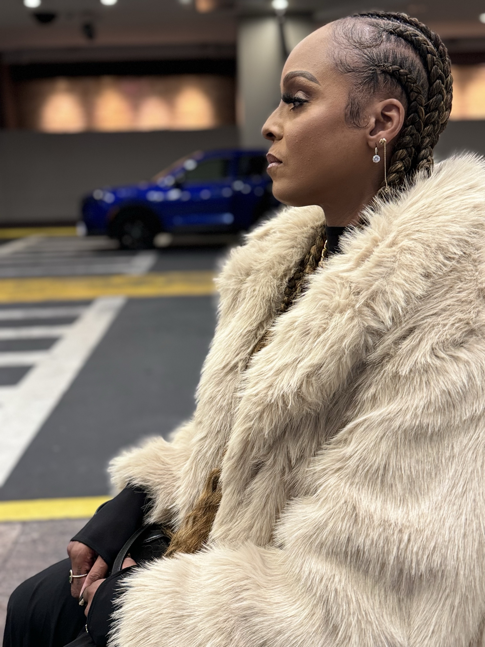 Profile portrait of Angela Hunte in a cream coat
